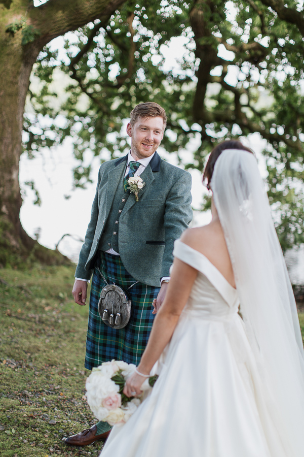 groom looking at bride with evening light
