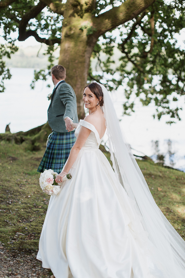 wedding photographer cameron house groom pulling bride