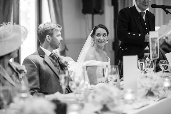 bride looking at groom during father