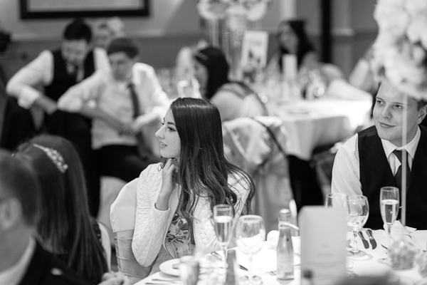 guests looking at groom during wedding speech