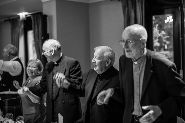 ministers standing and dancing during wedding