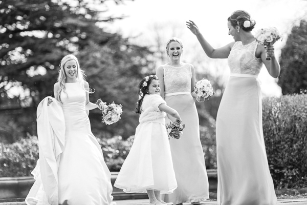 happy bridal party getting photrographed outside of mar hall