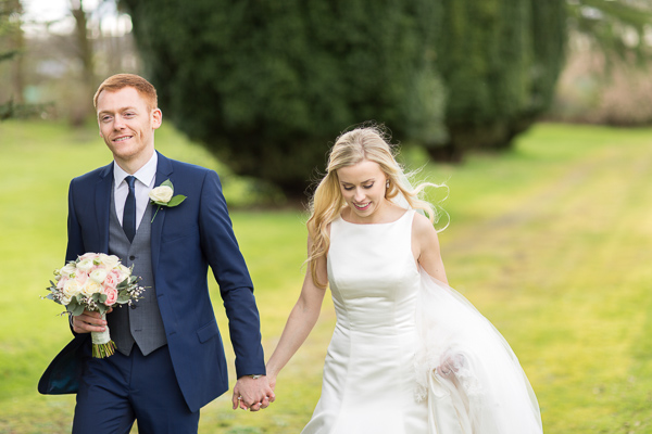 groom holding birdes hand at mar hall scotland