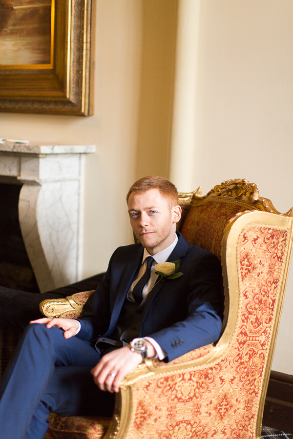 groom sitting in the armchair mar hall scotland 