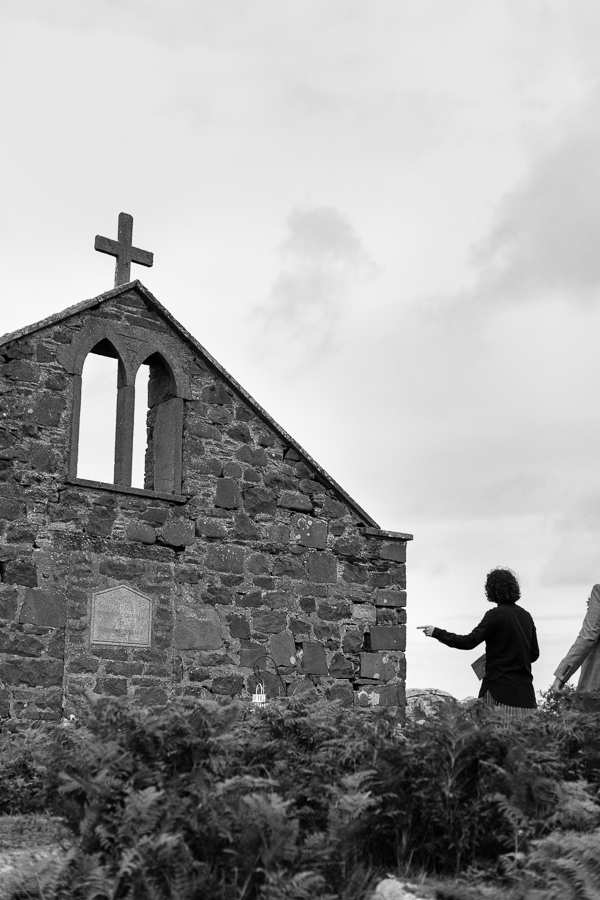 groom preparing for ceremony on a beach, church ruin in scotland