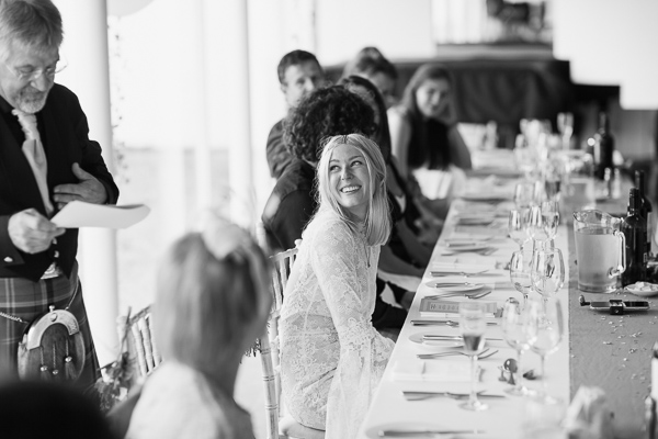 bride smiling at her dad during speeches