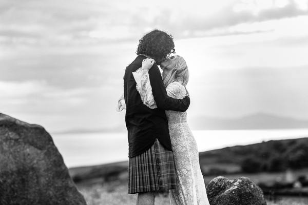 wedding photographer scotland groom and bride kissing on a hill