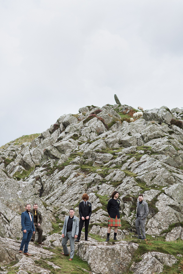 groom and his men on a rocky beach