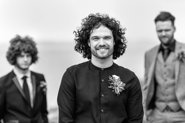 groom in black shirt looking cool scottish style