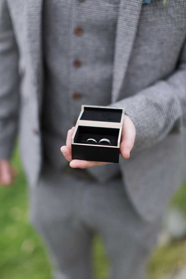 best man holding wedding rings