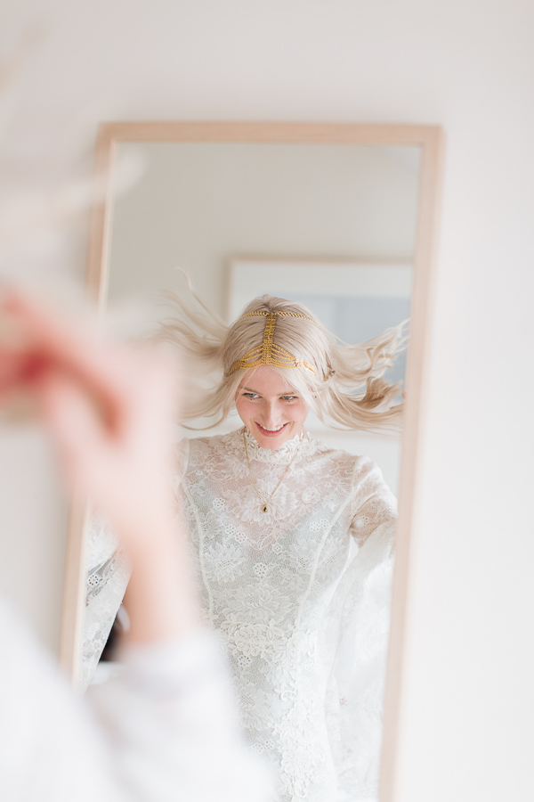 bride fixing her hair during preparations