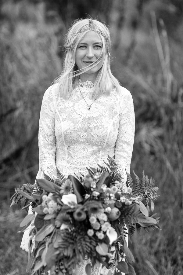 portrait of bride holding flowers and looking at the camera