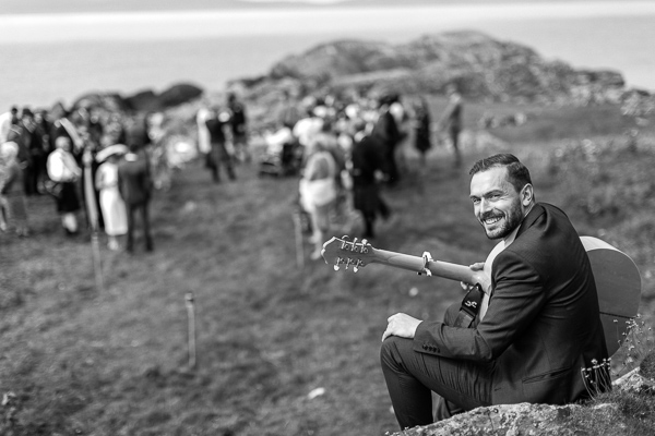 guitar player smiling playing at ceremony