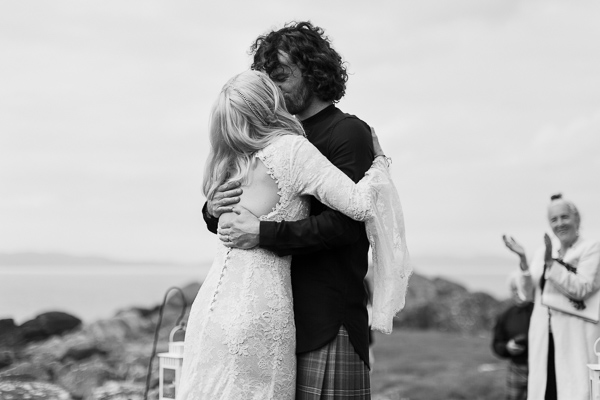 bride and groom kissing during outdoors ceremony
