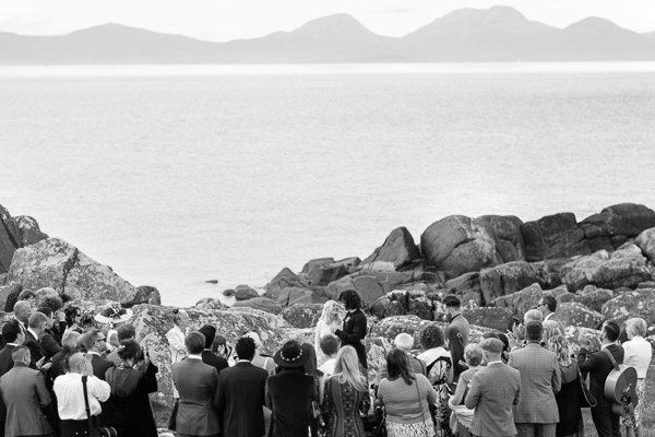 bride and groom about to kiss while guests watching