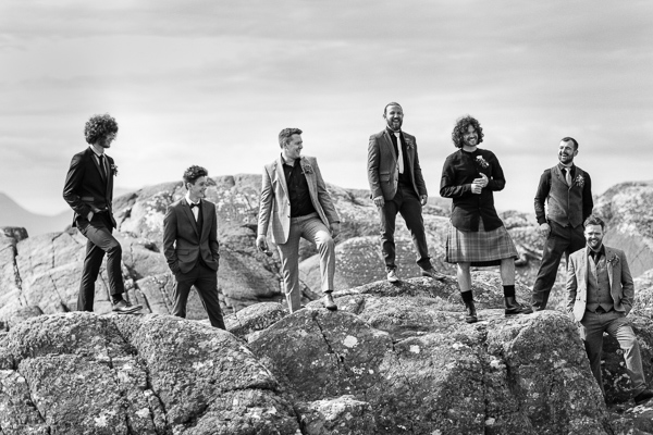 groom with groomsmen on a rock