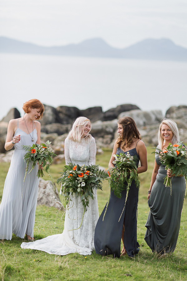 bridesmates and bride looking at each other and smiling