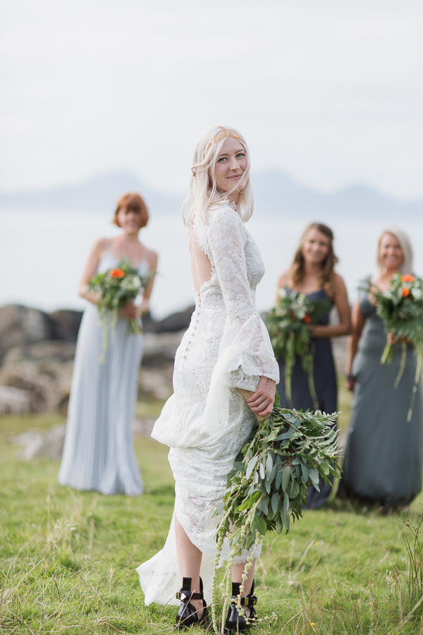 bride looking at the camera with bridesmates in the background