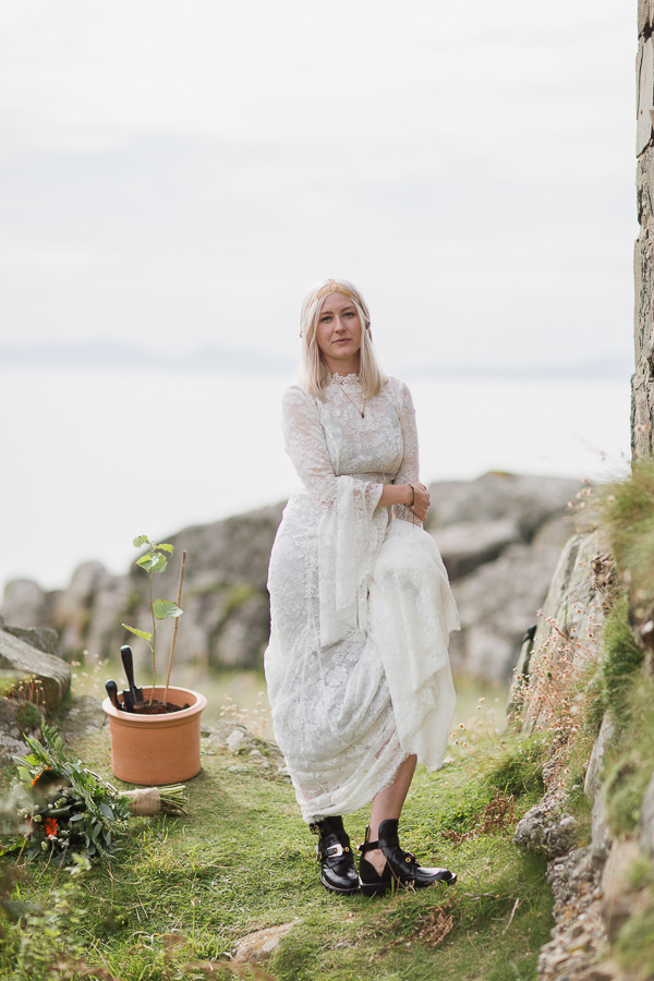 blond bride standing holding her dress