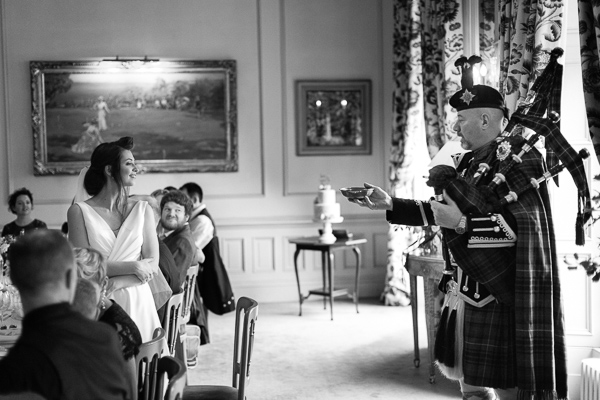 tradiotiona scottish piper whisky toast during wedding at dundas castle