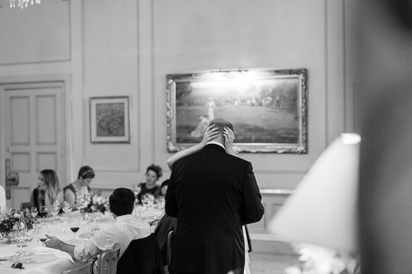 bride embracing groom during his wedding speech