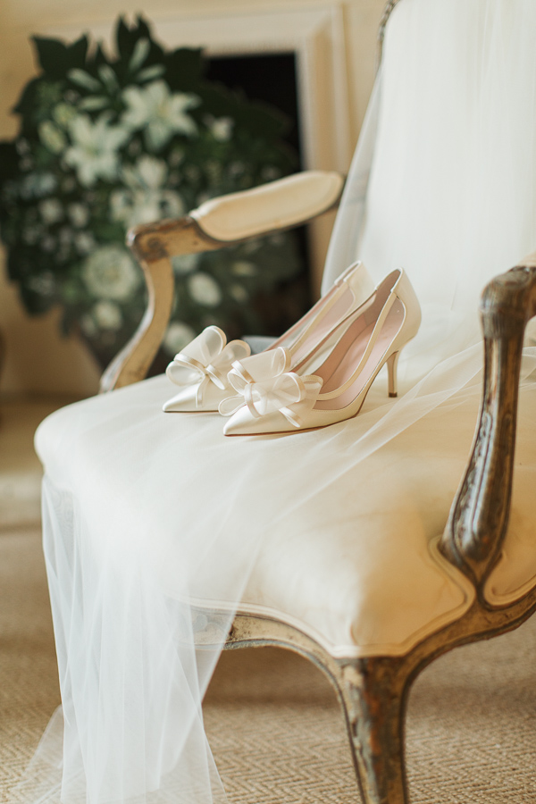 wedding shoes and veil on armchair