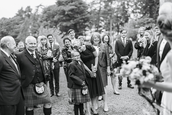 guests looking at newlyweds outside the church