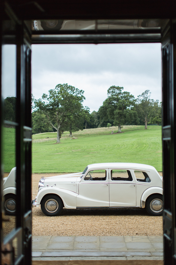 vintage wedding car parked in fron tof dundas castle scottish wedding venue