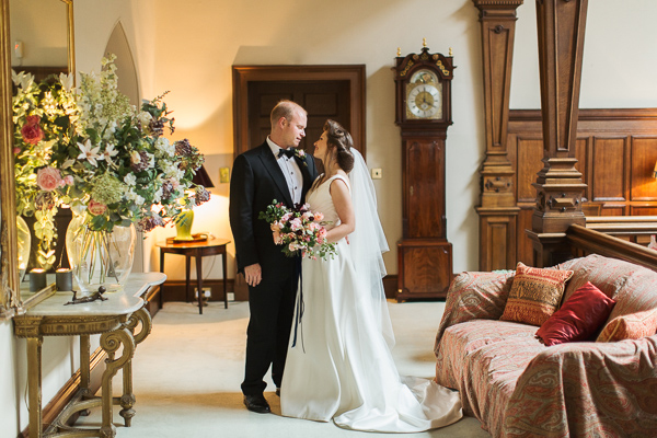 wedding couple holding each other in lovely interior of dundas castle