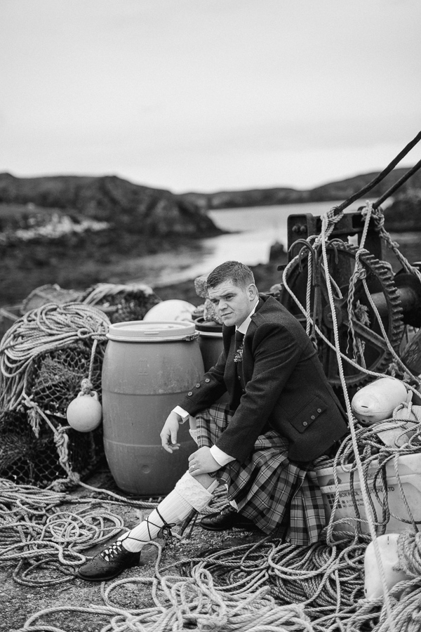 groom sitting on a harbour