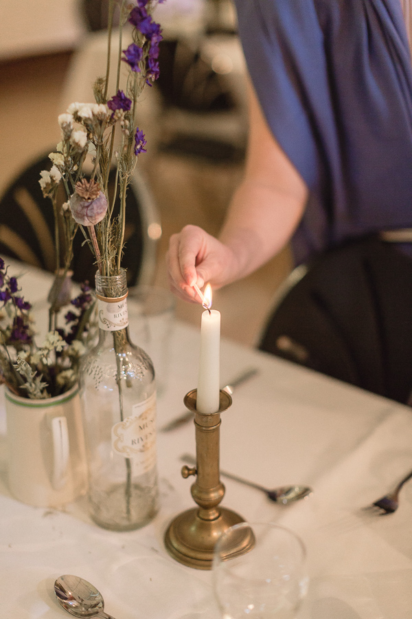 candels beeing lit at wedding reception