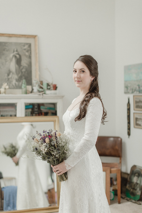 bride holding flowers and looking at the camera