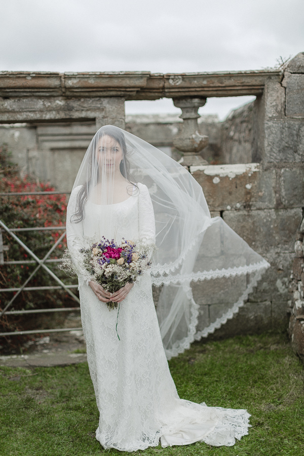 bride having her veil move by the wind scotland