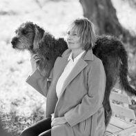 portrait woman with dog sitting in coat joga teacher