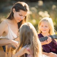 mother and two girls playing gitar family photos