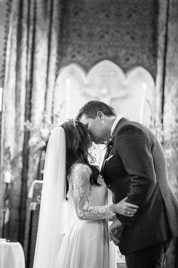 a couple kissing in the chapel at cromlix house 