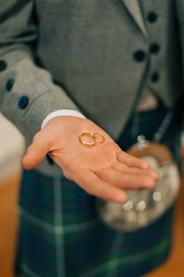 groom holds rings 