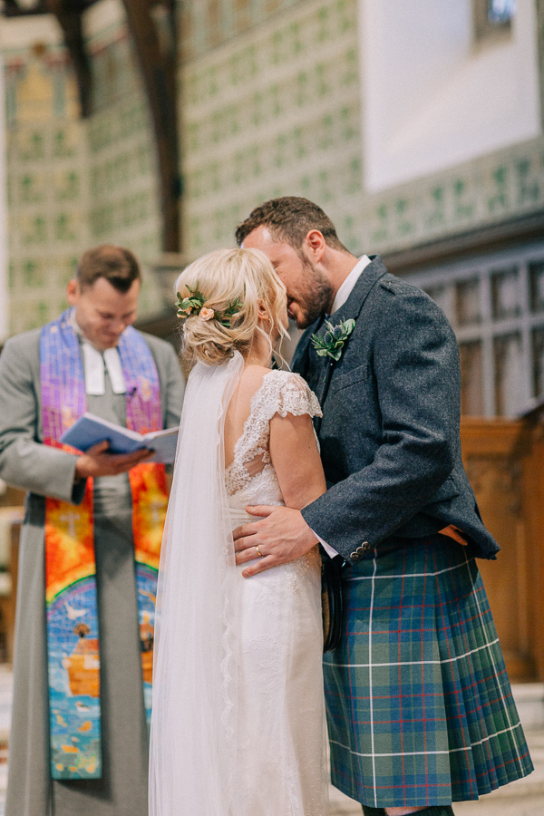 couple at the altar kissing 