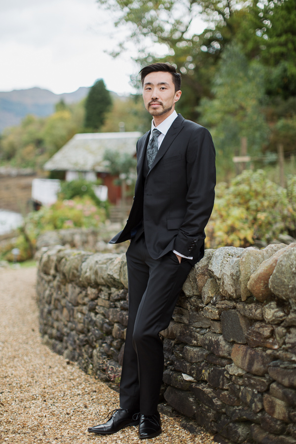 groom in full suit in garden 