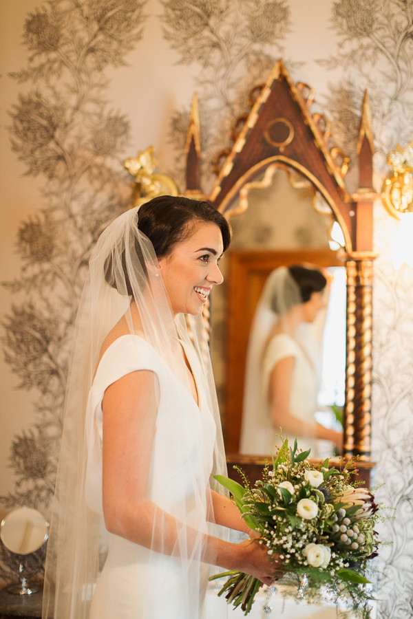 bride laughing holding her flowers