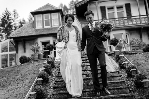 bride and groom walking down stairs to the garden