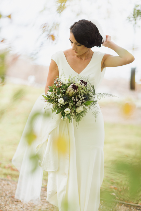 bride fising her veil during wedding sesion with photographer