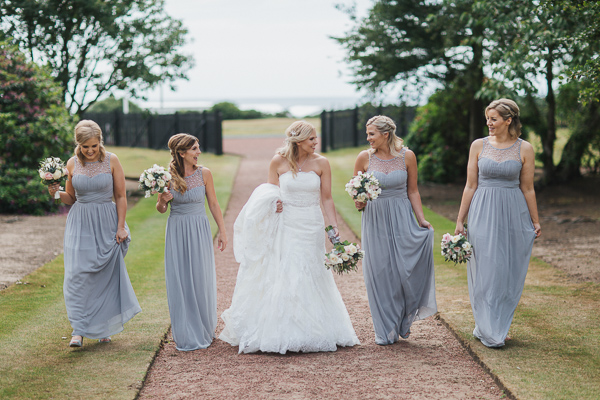 bride and bridesmates walking in the garden