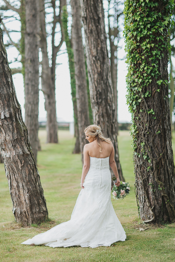 bride looking on the side in teh gardens