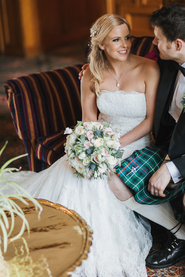 bride and groom sitting inside lochgreen hotel