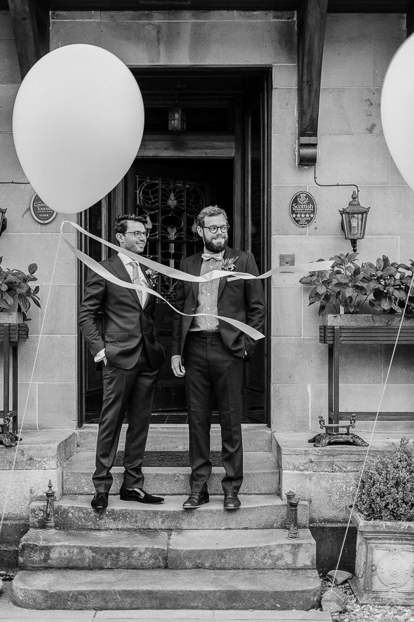 groom and bestman outside of the lodge on loch goil