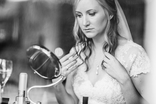 bride looking at the mirro at the lodge on loch goil 