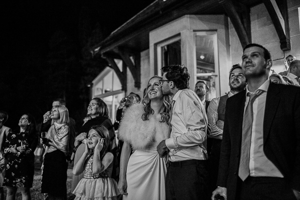 bride and groom kissing during fireworks at the lodge on loch goil in scotland