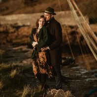 engagement photos in scotland two people huging in an old harbour in scotland