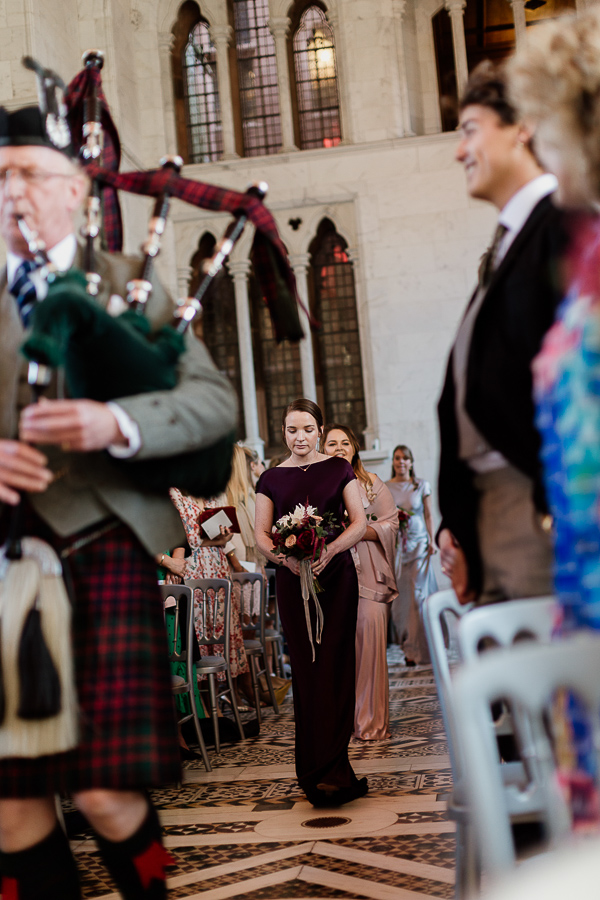 bridesmates led by piper wlaking down the aisle white chapel mount stuart